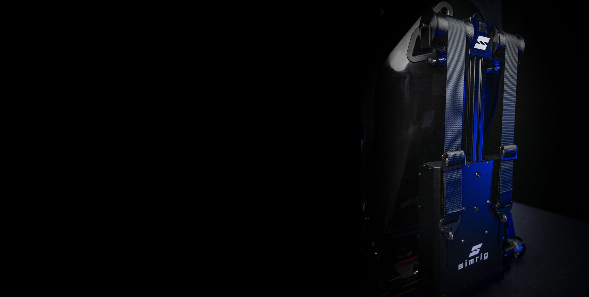 SIMRIG SBM behind a racing seat, harness hooked in