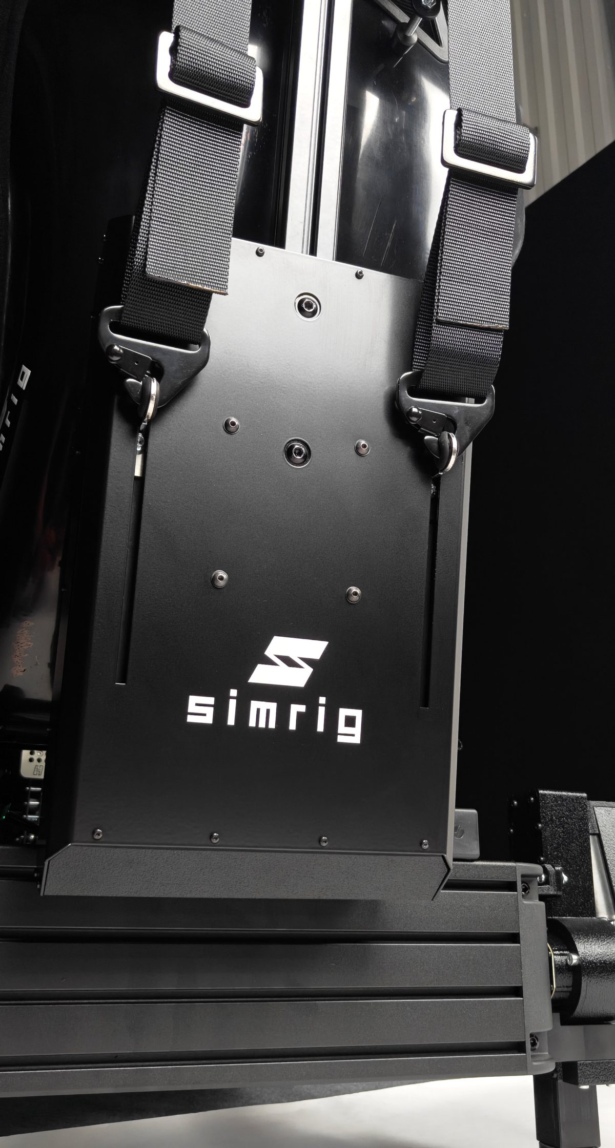 Both shoulder straps hooked into the SIMRIG Belt Module, seen from behind the seat